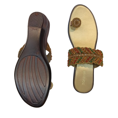 Beaded sandal with a detailed sole on a white background