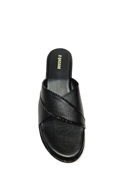 Black sandal with criss-cross strap design on a white background